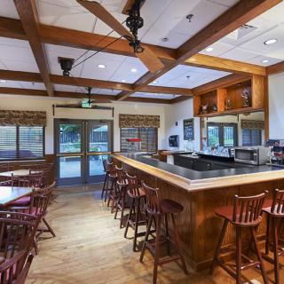An empty restaurant bar with wooden furnishings and a cozy atmosphere.