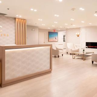 Modern reception area with elegant furniture and bright lighting.