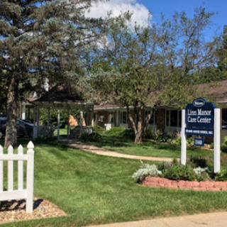 A sunny view of a care center with well-maintained lawns and trees.