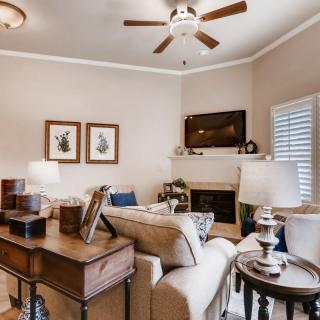 A cozy living room with comfortable seating, warm lighting, and tasteful decor.