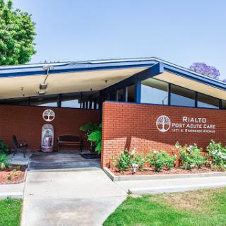 The exterior view of a community center showcasing modern architectural design and well-maintained landscaping.