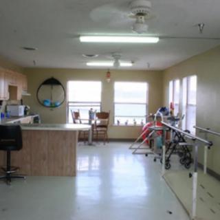 A rehabilitation clinic with exercise equipment and a treatment area.