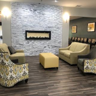 A modern lobby area featuring stylish seating and a cozy fireplace.