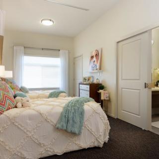 A cozy and well-decorated bedroom with a comfortable bed and modern furnishings.