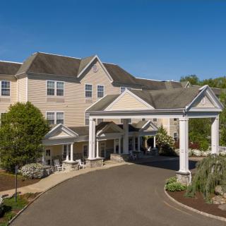 A grand building entrance with columns and a circular driveway.