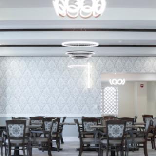 A modern dining area featuring elegant furniture and stylish lighting.
