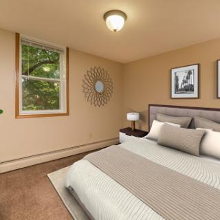 A cozy bedroom with modern decor and natural light filtering through the window.