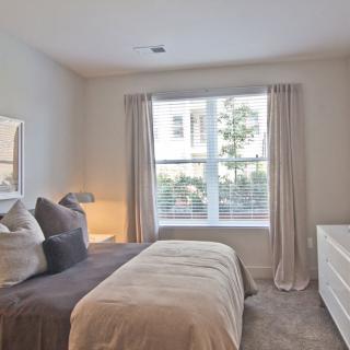 A cozy bedroom with soft, neutral colors and stylish decor.