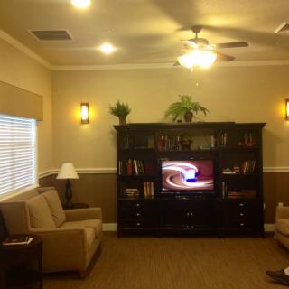 A cozy living room with a television and comfortable seating.