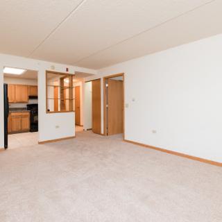 Spacious and inviting living area with a view into the kitchen.