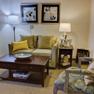 A cozy living room with a sofa, coffee table, and decorative elements.