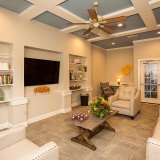 A modern and cozy living room with a large television, comfortable seating, and stylish decor.
