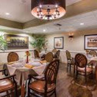 A cozy restaurant dining area with elegantly set tables and chairs.