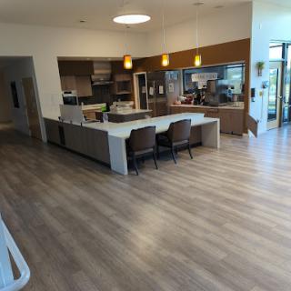 A modern kitchen and dining area with sleek design and open space.