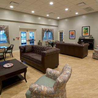A spacious and well-decorated lounge area with comfortable seating and modern decor.
