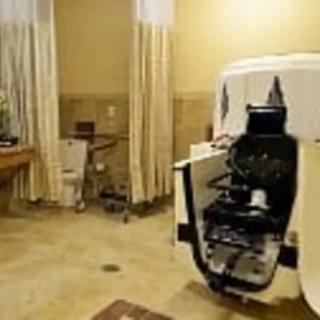 A dental clinic room featuring a modern dental chair and equipment.
