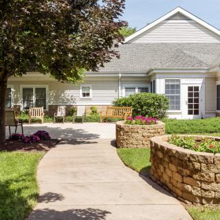 A charming house with a landscaped garden and pathway.
