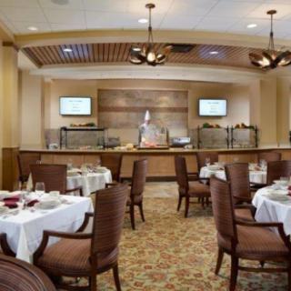 Elegant restaurant interior with dining tables and buffet setup.
