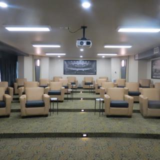 A conference room with arranged seating and a projector for presentations.