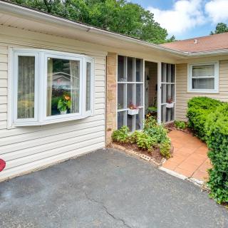 A cozy house exterior with a front porch and driveway.