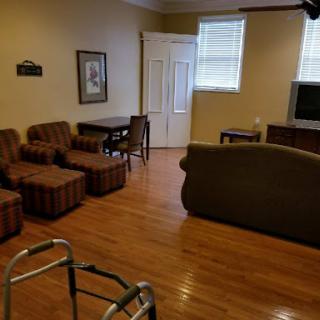 A cozy living room featuring comfortable seating and a warm wooden floor.