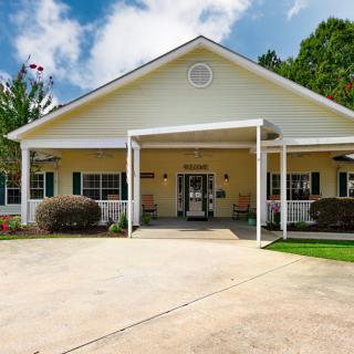 A suburban residential building with a driveway and porch.