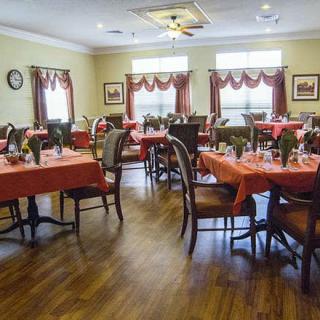 A beautifully decorated dining room with tables set for a meal.