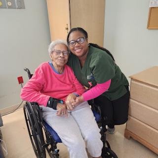 A caregiver sharing a warm moment with an elderly resident in a care facility.