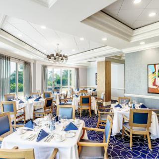 An elegantly arranged dining room featuring modern decor and a serene view.