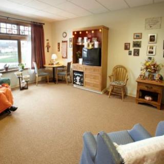 A cozy living room with a comfortable seating arrangement, television, and charming home decor.