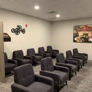 A small indoor theater with rows of comfortable seating and movie-themed decor.