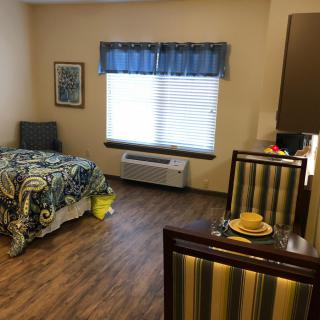 A cozy bedroom with a single bed and wooden flooring.