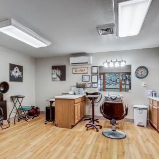 A well-equipped hair salon with chairs, mirrors, and styling tools.