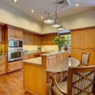 A modern kitchen with wooden cabinets and an island countertop.