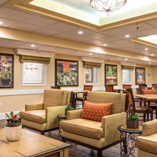 A stylish lobby seating area with comfortable chairs, decorative elements, and warm lighting.