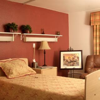 A cozy bedroom featuring warm tones, comfortable furniture, and decorative elements.