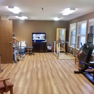 A well-equipped physical therapy room with exercise and rehabilitation equipment.