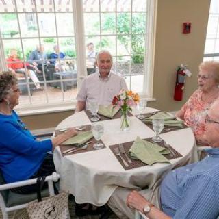 A group of seniors enjoying a meal together at a restaurant.