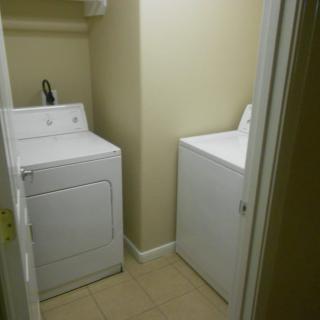 A compact laundry room featuring a washer and dryer.
