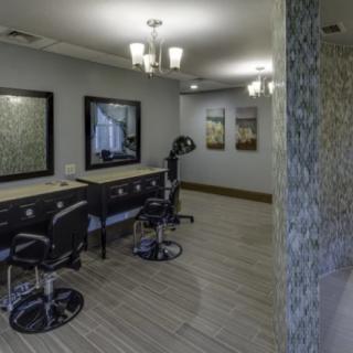 A modern salon interior with stylish chairs and mirrors.