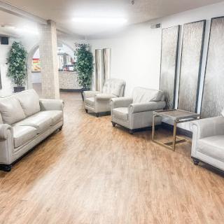A modern and inviting lobby area featuring comfortable seating and greenery.