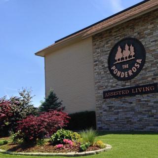 A well-maintained assisted living facility with attractive landscaping and clear signage.