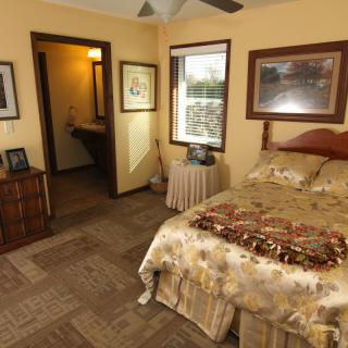 A cozy bedroom with warm lighting and elegant decor.
