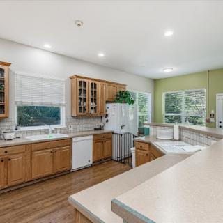 A spacious and inviting kitchen featuring wooden cabinets and ample natural light.