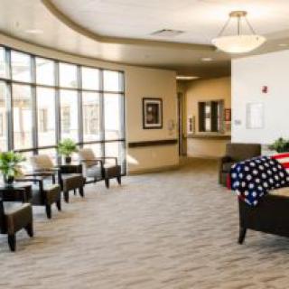 A spacious and well-lit lobby area with comfortable seating and large windows.