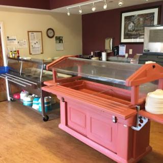A cozy caf setting featuring a buffet service area with food displays.