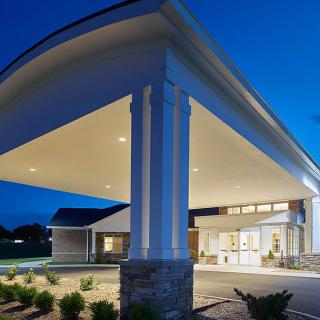 A modern building entrance illuminated at night.