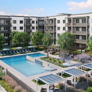 A modern apartment complex featuring a central swimming pool and landscaped outdoor spaces.