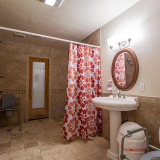 A cozy bathroom with a floral shower curtain and elegant fixtures.