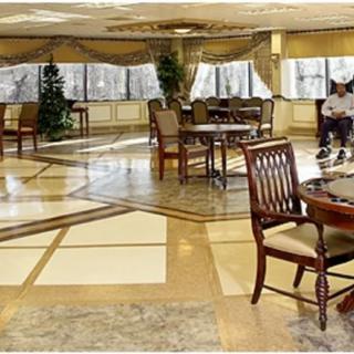 Spacious dining area with elegant furniture and large windows letting in natural light.